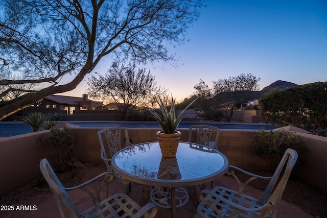 view of patio terrace at dusk