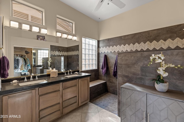 bathroom featuring a wealth of natural light, tile walls, tile patterned floors, and vanity