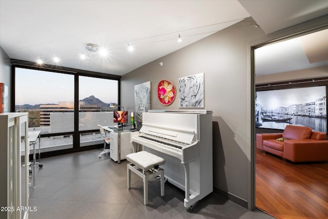 miscellaneous room featuring track lighting and floor to ceiling windows