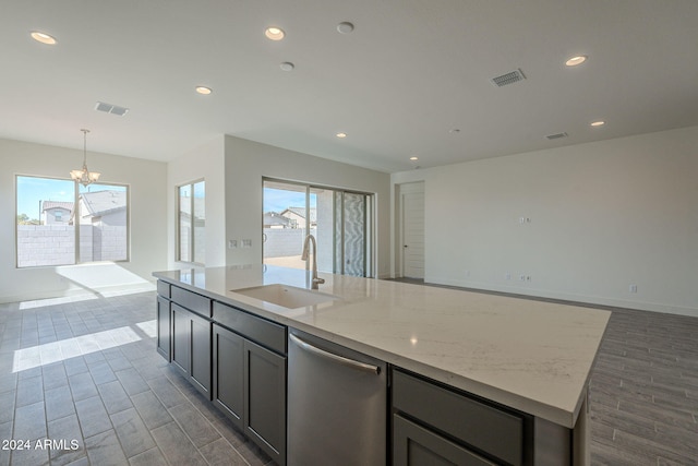 kitchen featuring light stone counters, stainless steel dishwasher, dark wood-type flooring, and sink