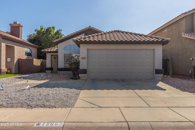 mediterranean / spanish home featuring a garage