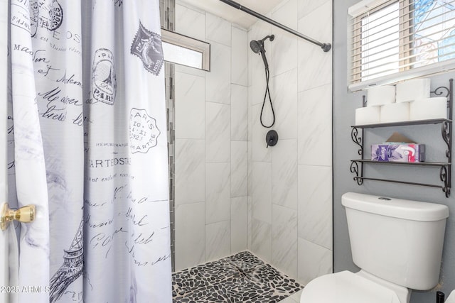 bathroom with curtained shower and toilet