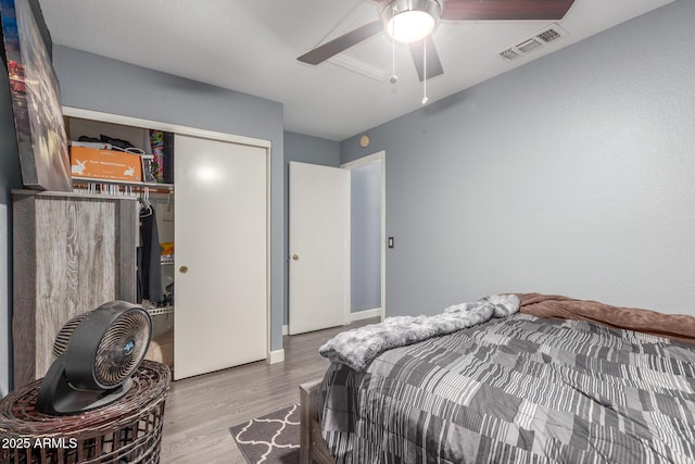 bedroom featuring hardwood / wood-style flooring, a closet, and ceiling fan