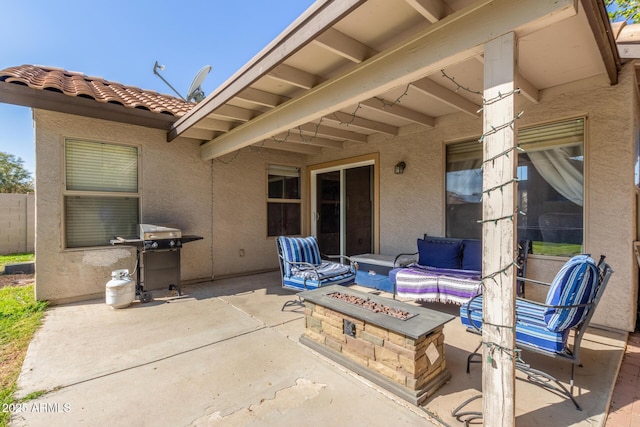 view of patio with area for grilling and an outdoor fire pit