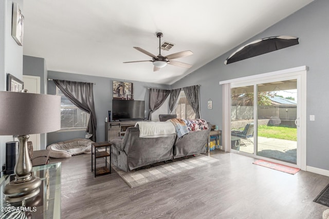 bedroom with ceiling fan, lofted ceiling, access to exterior, and hardwood / wood-style floors