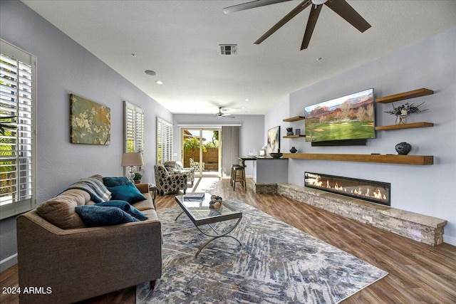 living room featuring ceiling fan and hardwood / wood-style flooring