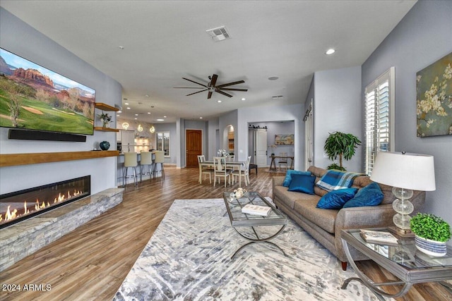 living room with ceiling fan and hardwood / wood-style flooring