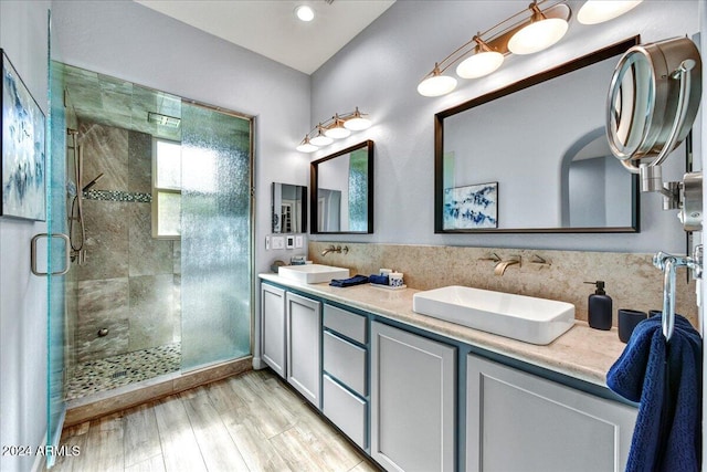 bathroom featuring a shower with door, vanity, and wood-type flooring