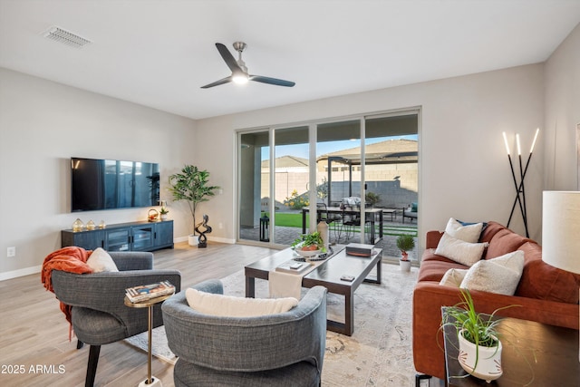 living room with light hardwood / wood-style flooring and ceiling fan