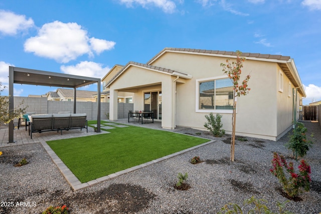 back of property featuring a lawn, a patio area, and an outdoor hangout area