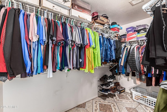 walk in closet with tile patterned floors