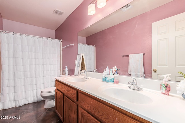 bathroom featuring toilet, tile patterned flooring, visible vents, and a sink