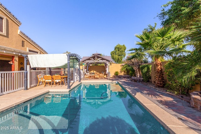 view of pool with a fenced backyard, a fenced in pool, and a gazebo