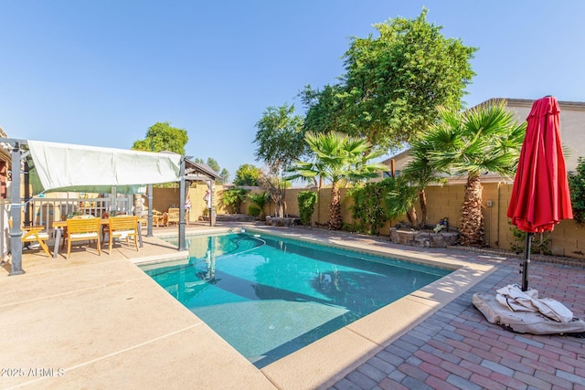 view of swimming pool featuring a patio, a fenced backyard, and a fenced in pool