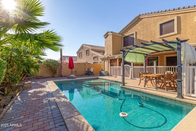 view of swimming pool featuring a fenced in pool, a patio area, a fenced backyard, and a pergola