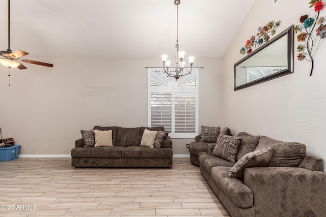 living room with vaulted ceiling, light wood finished floors, ceiling fan with notable chandelier, and baseboards