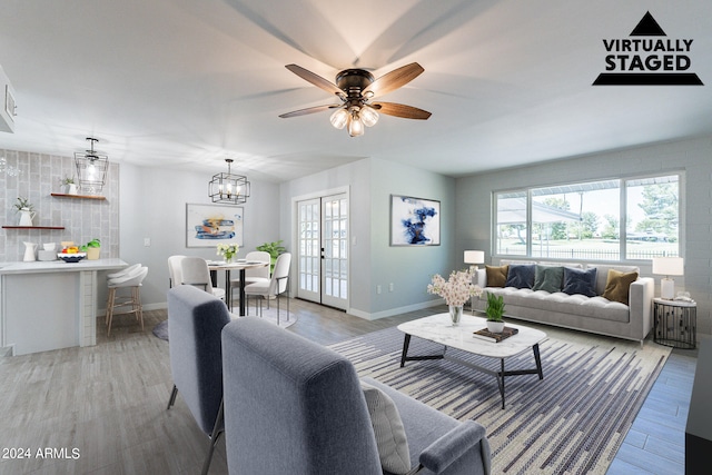 living room with french doors, a healthy amount of sunlight, light hardwood / wood-style flooring, and ceiling fan