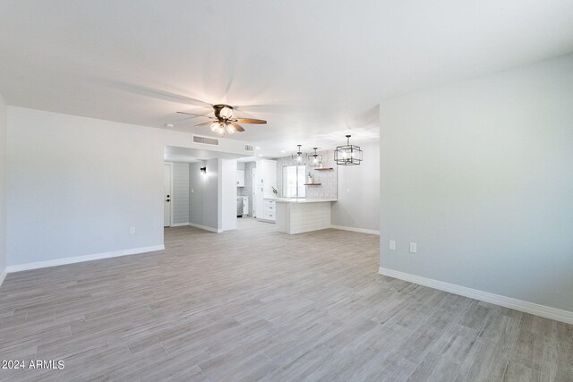 unfurnished living room with ceiling fan and light wood-type flooring