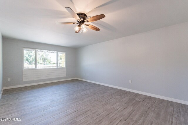 spare room with ceiling fan and light hardwood / wood-style floors