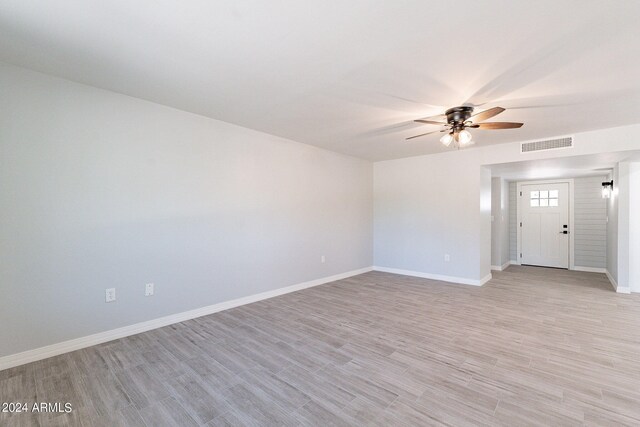 spare room with light hardwood / wood-style flooring and ceiling fan