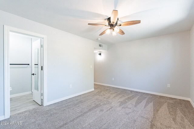 carpeted empty room with ceiling fan