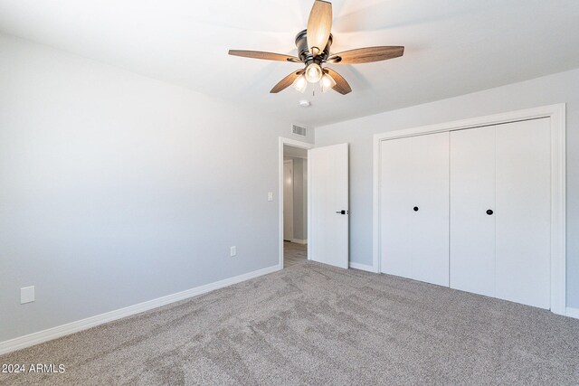 unfurnished bedroom with a closet, ceiling fan, and carpet floors