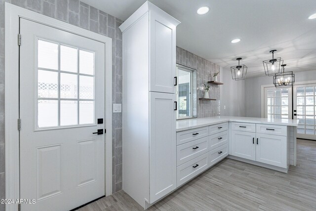 interior space featuring plenty of natural light, light hardwood / wood-style floors, and french doors