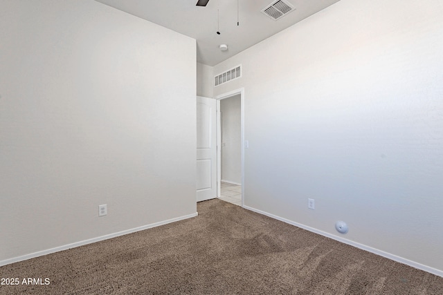 carpeted spare room with ceiling fan