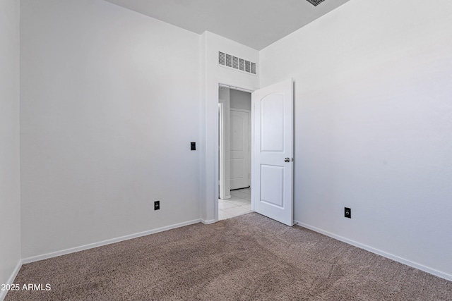 unfurnished room with light colored carpet