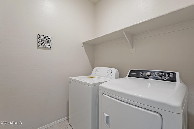 laundry room with light tile patterned flooring and washer and dryer