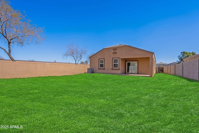 rear view of house with a yard and central air condition unit