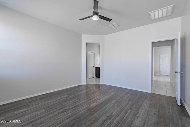 empty room featuring ceiling fan and dark hardwood / wood-style flooring