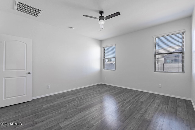 unfurnished room featuring dark wood-type flooring and ceiling fan