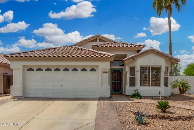 1653 E Gail Dr, Chandler, AZ 85225 - mediterranean / spanish-style home featuring concrete driveway, an attached garage, stucco siding, and a tile roof