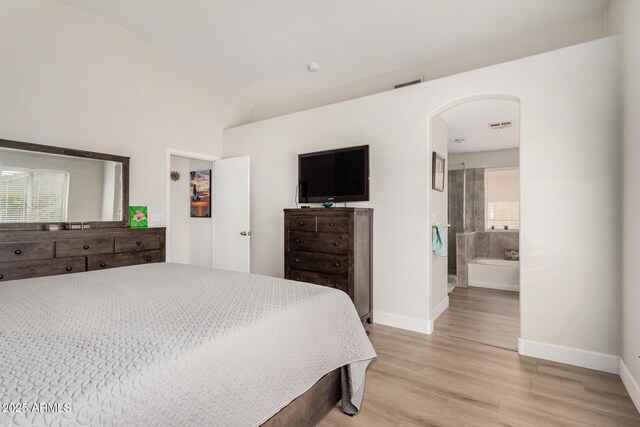 1653 E Gail Dr, Chandler, AZ 85225 - bedroom featuring baseboards, lofted ceiling, light wood-style flooring, arched walkways, and ensuite bath