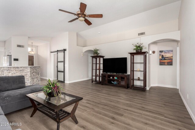 1653 E Gail Dr, Chandler, AZ 85225 - living area featuring a barn door, arched walkways, ceiling fan, and wood finished floors