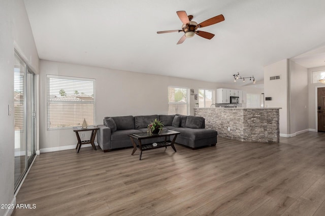1653 E Gail Dr, Chandler, AZ 85225 - living area featuring light wood-type flooring, ceiling fan, baseboards, and rail lighting