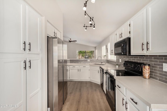 1653 E Gail Dr, Chandler, AZ 85225 - kitchen with black appliances, a sink, vaulted ceiling, tasteful backsplash, and white cabinets