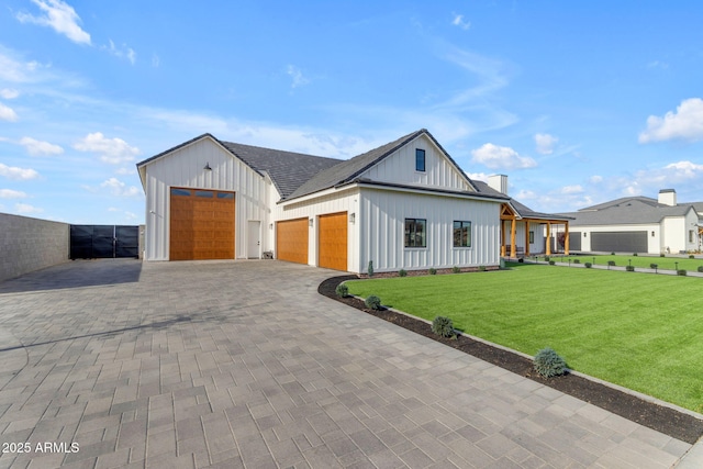 modern farmhouse style home with a garage and a front yard