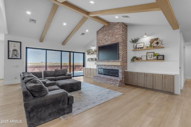 living room featuring a brick fireplace, light hardwood / wood-style flooring, high vaulted ceiling, and beamed ceiling