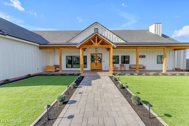 view of front of house with a porch and a front lawn