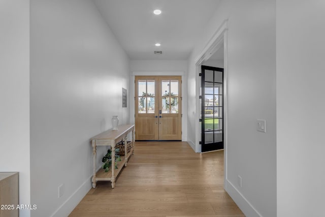 doorway to outside with light hardwood / wood-style flooring and french doors