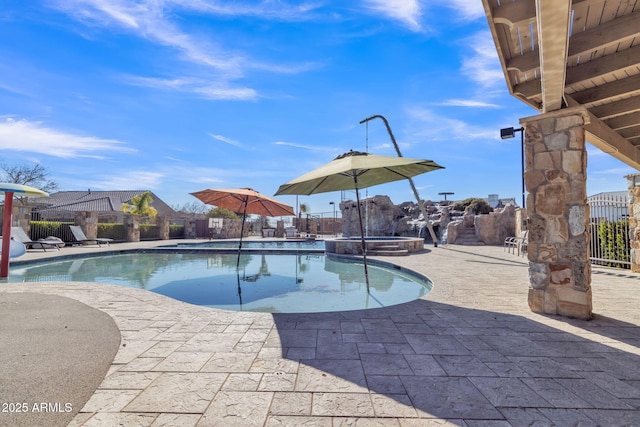 view of swimming pool featuring an in ground hot tub and a patio area