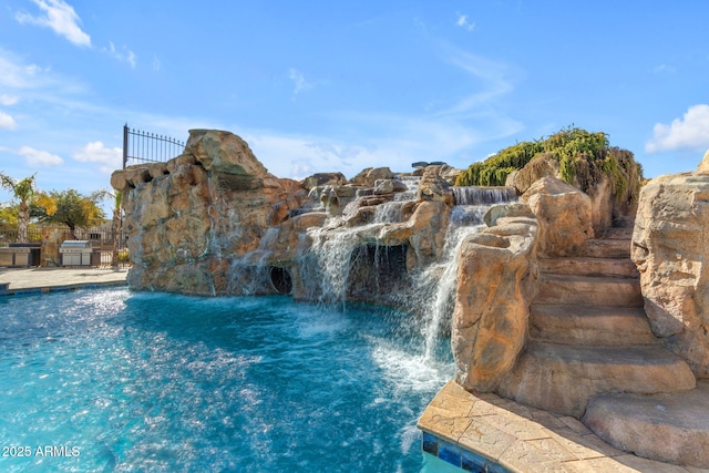 view of pool with pool water feature