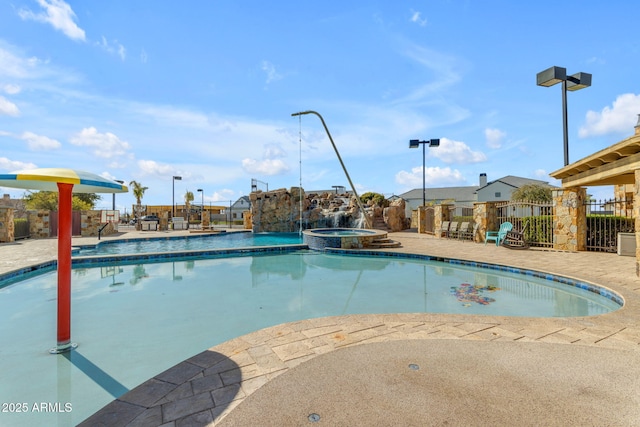 view of swimming pool with an in ground hot tub and a patio area