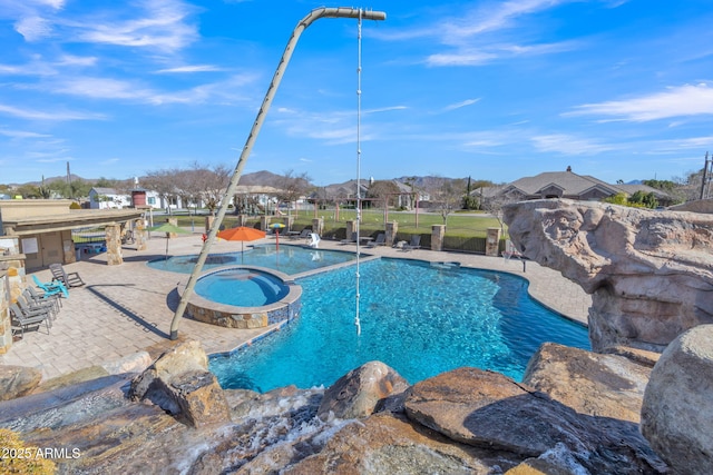 view of pool with an in ground hot tub and a patio