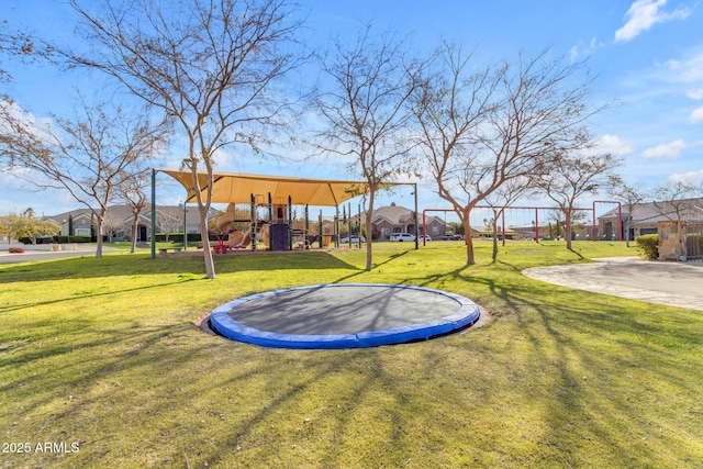 view of yard featuring a playground and a trampoline