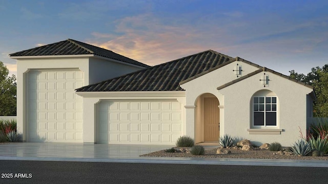 view of front of property with a garage, driveway, and stucco siding