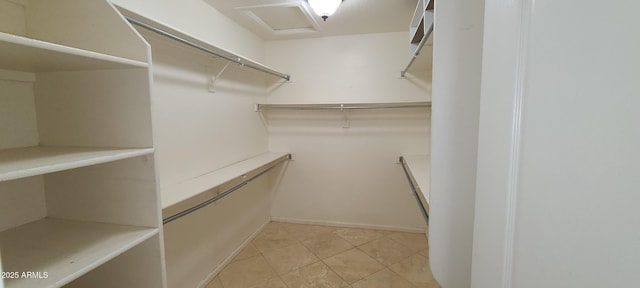 spacious closet featuring light tile patterned floors