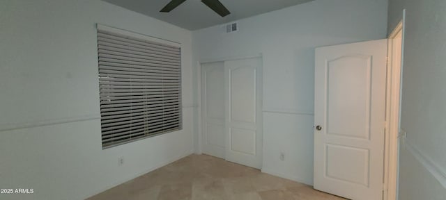 unfurnished bedroom featuring visible vents, a closet, and ceiling fan